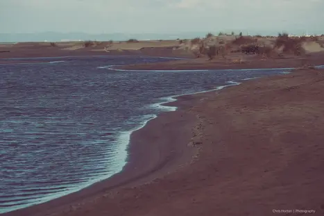 S-shaped blue line where beach meets sea at Plage de l’Espiguette, Le Grau du Roi.