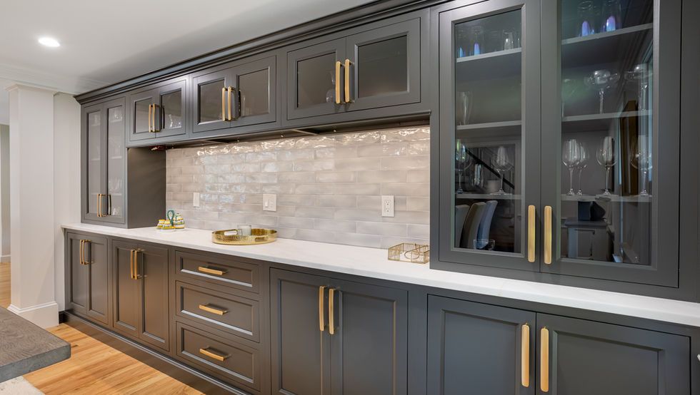 Dark gray kitchen cabinetry with gold handles in Littleton.