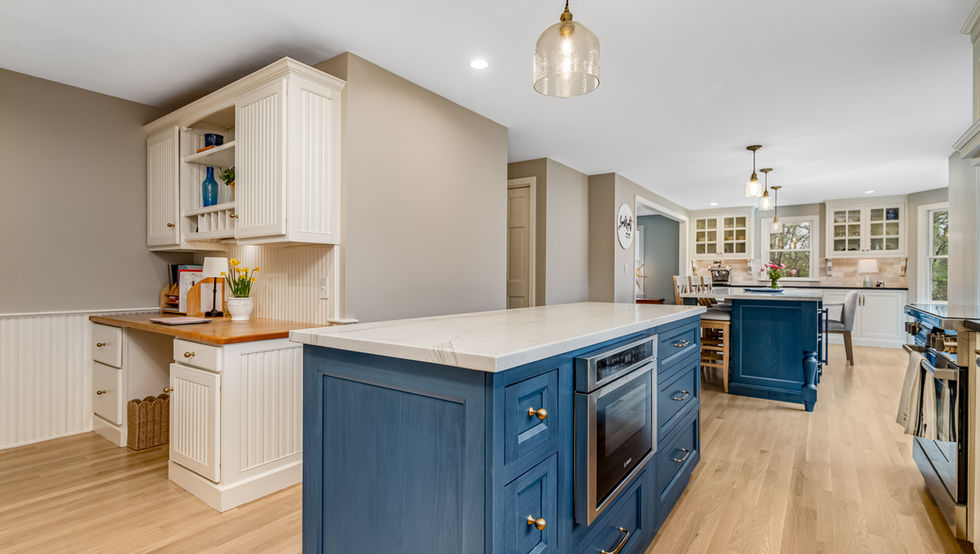 Modern kitchen with a blue island and marble countertop
