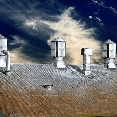 Photo of a rusted industrial warehouse rooftop in Oakland, California.