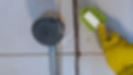 Shocked man discovering severe black mold growth on a kitchen wall beneath cabinets.