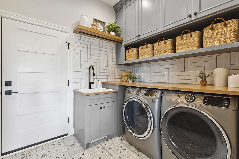 Modern laundry room with storage baskets, cabinets, and washer dryer setup designed for organized home utility spaces.