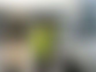 Courier inspecting delivery van tyres at depot