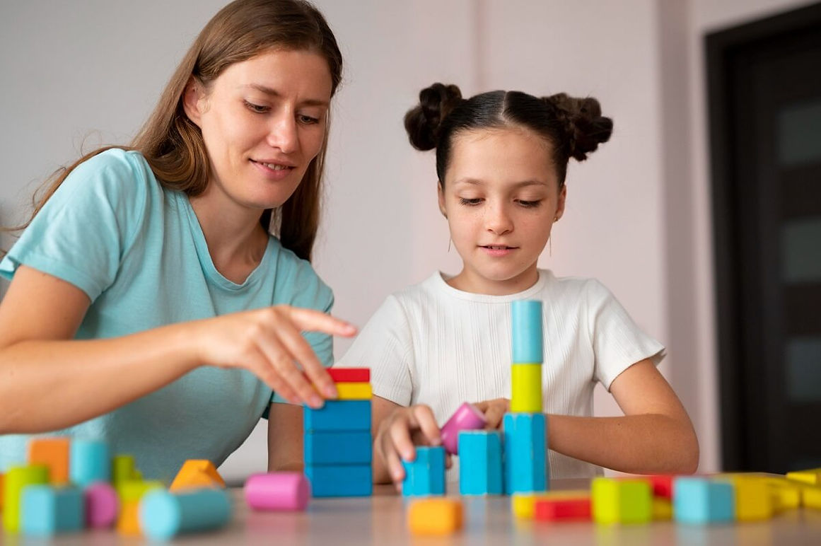 young-female-psychologist-helping-girl-speech-therapy.jpg