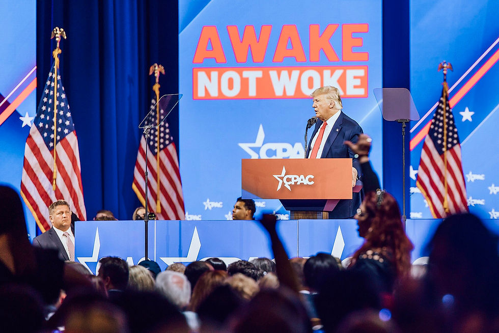 https://commons.wikimedia.org/wiki/File:CPAC_2022_con_Hermann_Tertsch_y_Victor_Gonzalez._(51915407623)_Cropped_extract_Donald_Trump_Speech_Awake_Not_Woke_Slogan.jpg