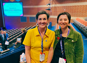 Naomi & Shona smiling to camera at a teaching conference