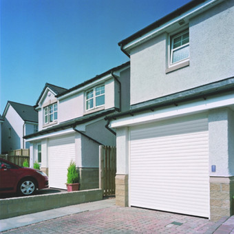 White Roller Door on a house with a driveway and windows with a car parked, Severn Garage Door Services Ltd