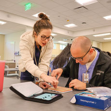 Nurse educator helping student