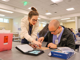 Nurse educator helping student