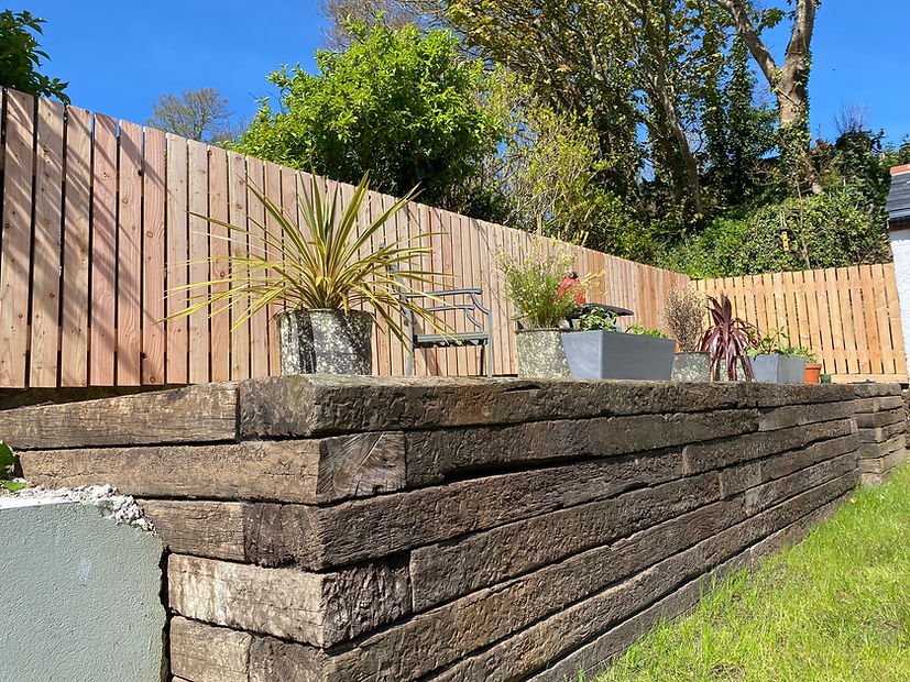 Beautifully Weathered Azobe Tropical Hardwood Reclaimed Sleepers with Planed Larch Fencing.jpeg