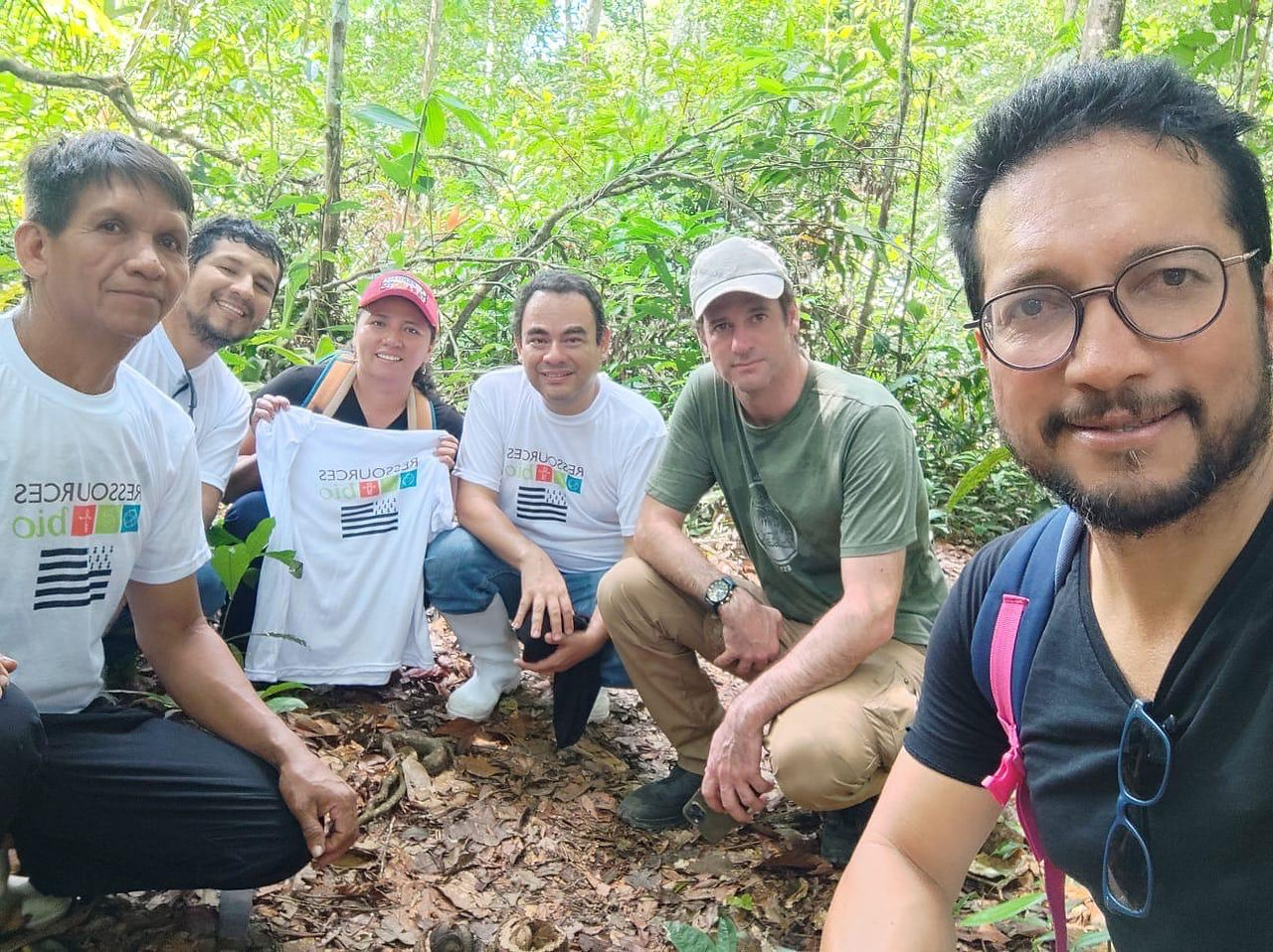 Team kneeling in the forest