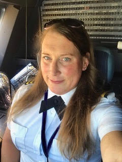 Female pilot taking a selfie in an airplane cockpit