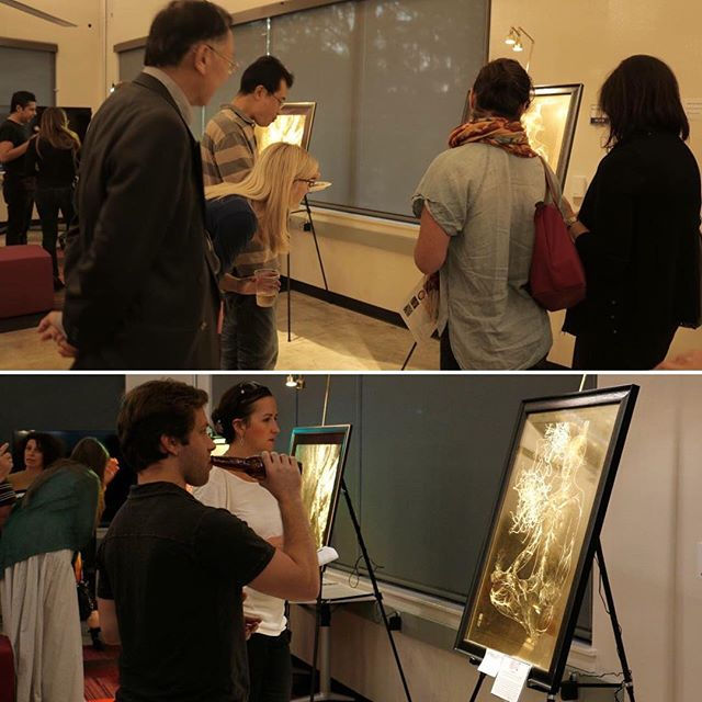 Essinova Salon guests admiring Dr. Dunn's neuro art