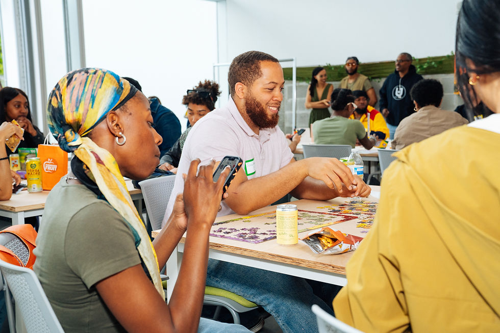 Attendees crafting, playing, and enjoying snacks at art making stations in The Green Room