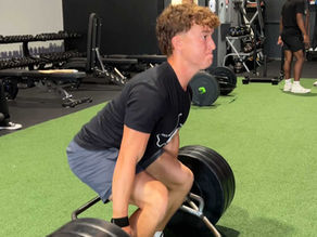 high school athlete performing strength training exercise