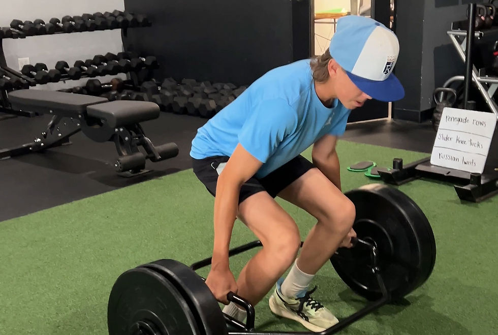 youth athlete performing hex bar deadlift at Barbell Coalition
