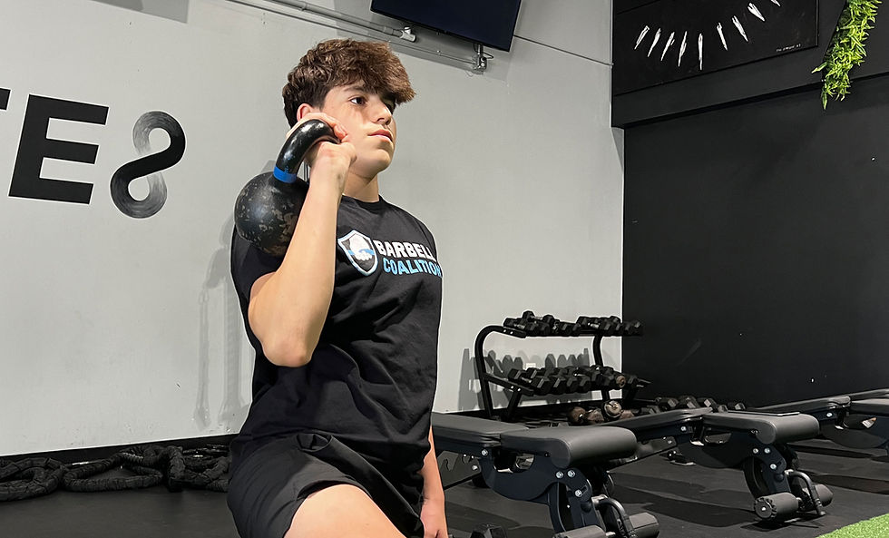 athlete performing kettlebell shoulder press exercise