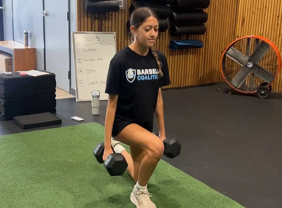 youth athlete performing dumbbell lunge exercise at Barbell Coalition