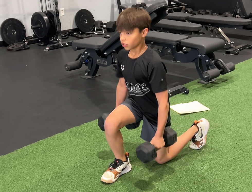 focused youth athlete performing dumbbell strength exercise