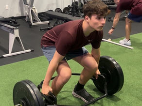 high school athlete performing deadlift exercise