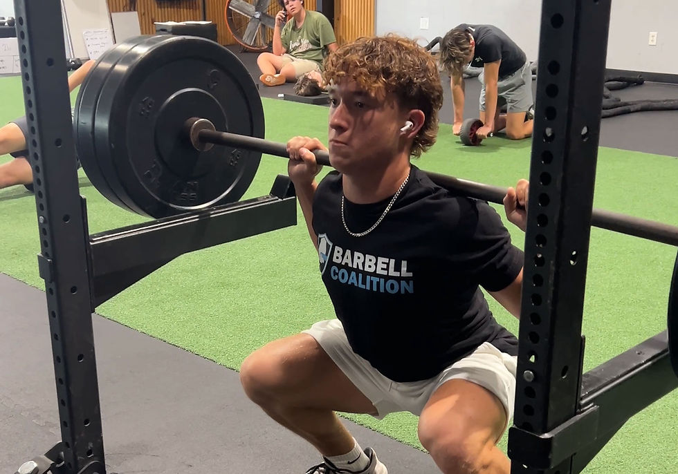youth football athlete performing barbell squat