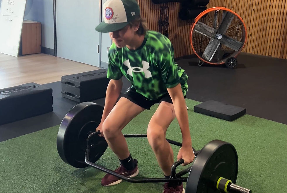 high school athlete performing hex bar deadlift