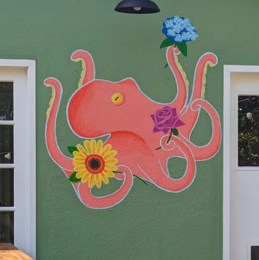 Mural of a pink octopus holding flowers