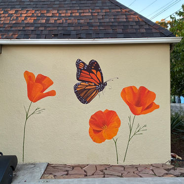 Mural of three California poppies and a monarch butterfly on a yellow wall