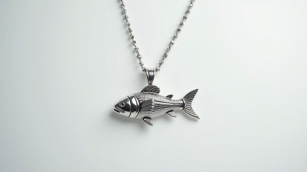 Close-up view of a silver fish pendant necklace on a white background