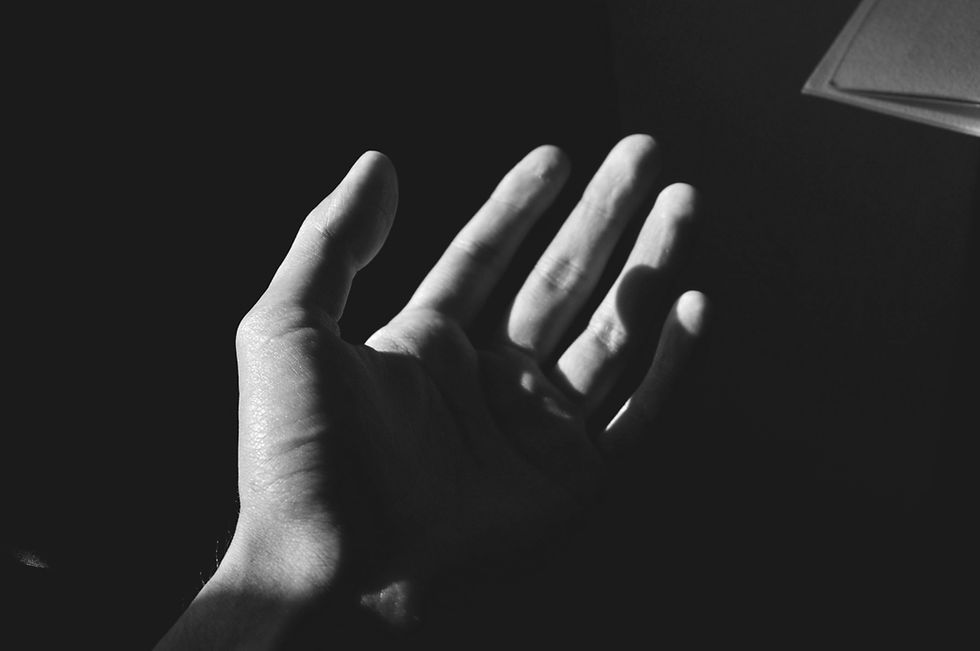 Hand reaching for support depicting somatic therapist in Los Angeles, discussing somatic therapy versus talk therapy for trauma.