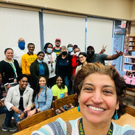 Diverse group of smiling people in a library setting