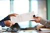 closeup-hands-passing-contract-unrecognizable-businessman.jpg
