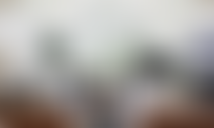 living room with a large grey sectional, black grand piano, and two matching leather chairs