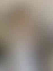 Back view of woman in ankle length blue and white floral dress with green sandals