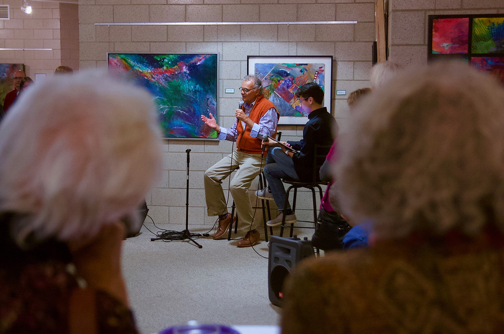 Artist speaking at a gallery opening event