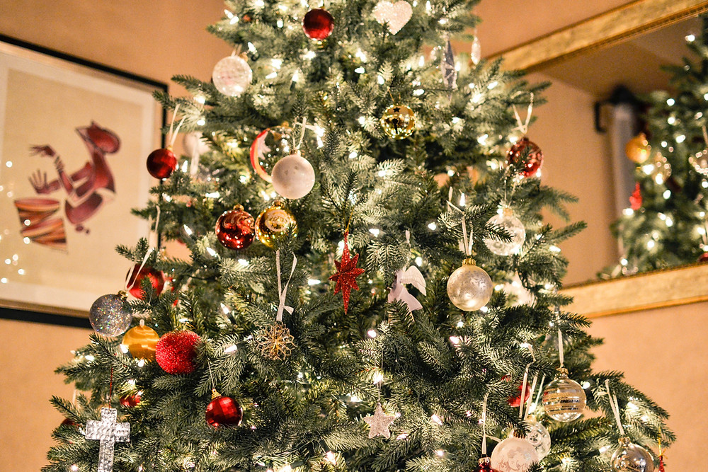 A Christmas tree decorated in red, white and gold.