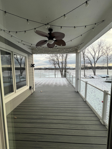 View of a frozen lake from a covered deck 