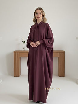 This abaya in a luxurious maroon shade blends timeless grace with a modern touch. The flow
