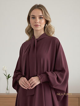 This abaya in a luxurious maroon shade blends timeless grace with a modern touch. The flow