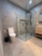 Apex Shower Repairs: Modern bathroom with waterproofed glass shower and tiling.