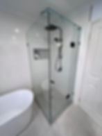 Apex Shower Repairs Modern frameless glass shower rebuild with black fixtures.