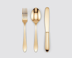Gold fork, spoon and knife on grey background