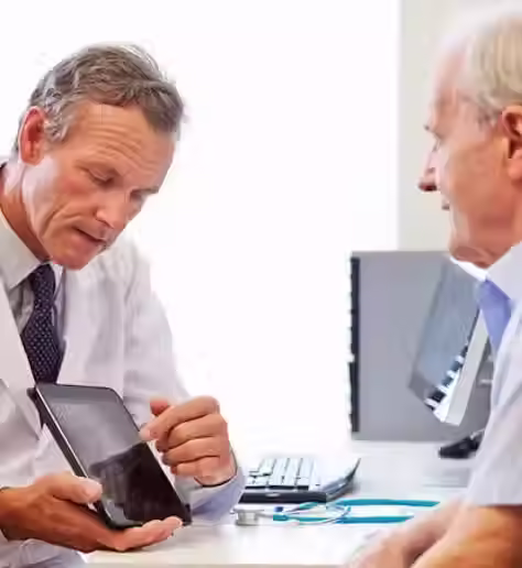 Doctor using a tablet to explain to a patient the process of DBS for Parkinson's Treatment