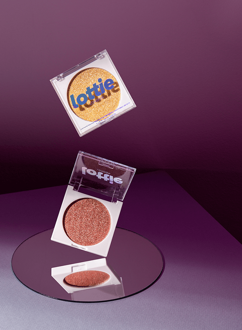 Commercial beauty product photography, lottie cosmetics. Professional still life photography of eye shadow. Unique style, surrealist, mirrored objects floating in the air.