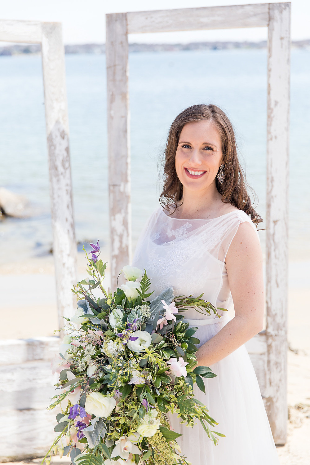 the bride is holding her bouquet and smiling
