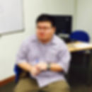 A portrait photo of Chern Jiek who is a physics tuition teacher and engineer sitting on an office chair