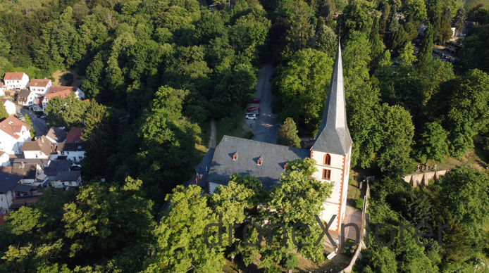 Warm, colloful, drone-picture of a small chapel or church in Auerbach, Germany.