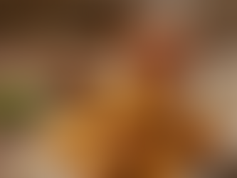 "Golden, crispy paneer pakoras served with mint-cilantro chutney, tamarind sauce, and a steaming cup of masala chai on a rustic wooden table."