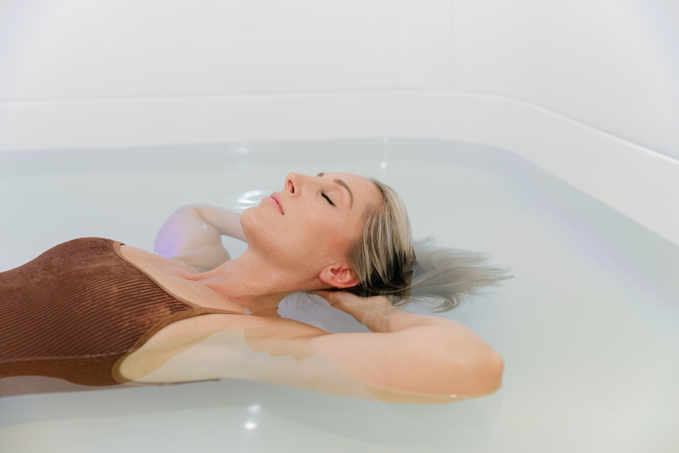 Guest floating on her back in still, shallow salt water