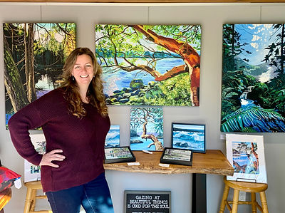 Lori Morris in her gallery surrounded by her artwork.